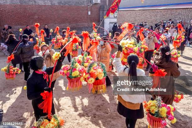 Villagers parade with flowery baskets in a traditional gatheirng to celebrate the lunar New Year in Huaxian county in central Chinas Henan province...