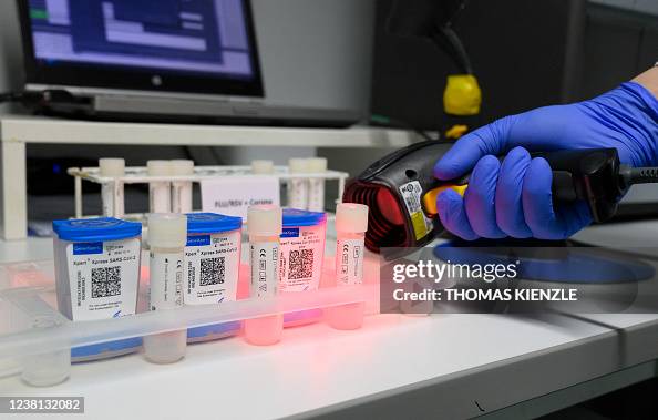 A medical staff member scans the codes of SARS-Cov 2 rapid tests in ...