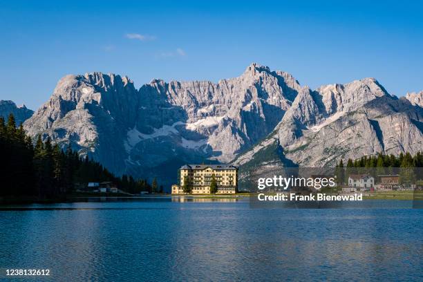 Lake and town Misurina, Lago di Misurina, with the mountain Punta Sorapiss reflecting in the water, Listituto Pio XII at the end of the lake.