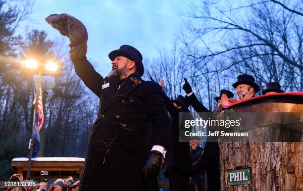 Groundhog handler AJ Derume holds Punxsutawney Phil, who saw his shadow, predicting a late spring during the 136th annual Groundhog Day festivities...