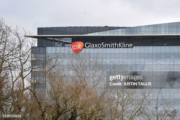 Photograph taken on February 2, 2022 shows the logo of the British multinational pharmaceutical company GlaxoSmithKline on top of its headquarters in...