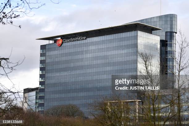Photograph taken on February 2, 2022 shows the logo of the British multinational pharmaceutical company GlaxoSmithKline on top of its headquarters in...