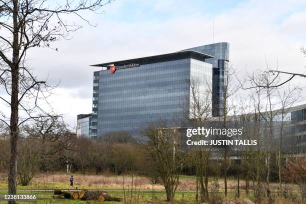 Jogger runs past the headquarters of the British multinational pharmaceutical company GlaxoSmithKline, in London, on February 2, 2022.