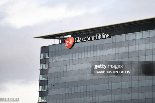 Photograph taken on February 2, 2022 shows the logo of the British multinational pharmaceutical company GlaxoSmithKline on top of its headquarters in...