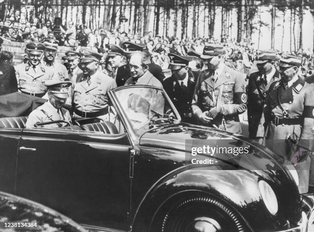 German chancelor Adolf Hitler inspects the first Volkswagen "Beetle" produced in Stuttgart in 1937.