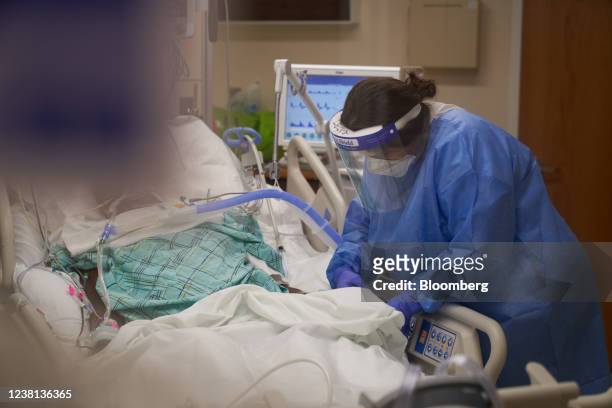 Healthcare worker treats a Covid-19 patient on the Intensive Care Unit floor at Hartford Hospital in Hartford, Connecticut, U.S., on Monday, Jan. 31,...