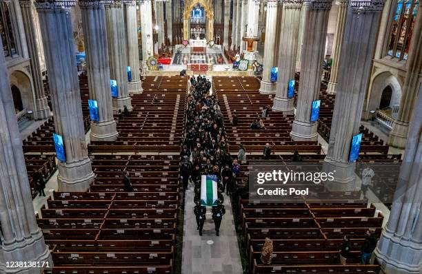 Slain NYPD officer Wilbert Mora casket is carried at the completion of a funeral service at St. Patricks Cathedral on February 2, 2022 in New York...