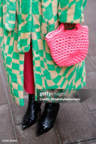 Influencer Lois Opoku wearing black boots by Jimmy Choo and a pink bag by Maiami, seen during Copenhagen Fashion Week Autumn/Winter 2022 on February...