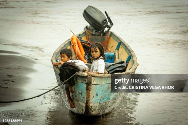 Children remain on a boat, after crude reached the Coca river due to an oil spill, in Puerto Maderos, Sucumbios province, Ecuador, on February 1,...