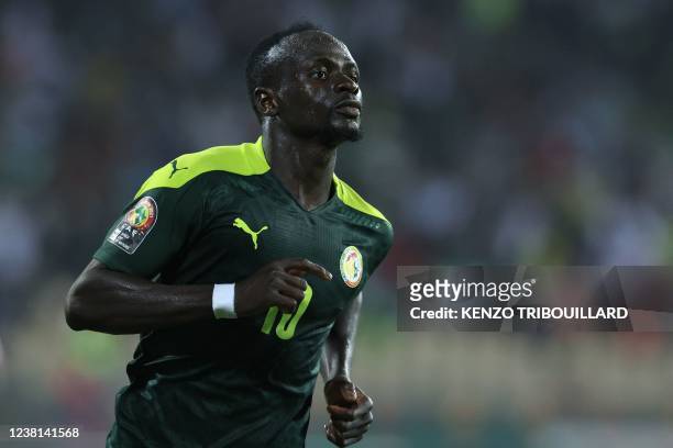 Senegal's forward Sadio Mane celebrates after scoring his team's third goal during the Africa Cup of Nations 2021 semi final football match between...