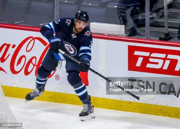 Brenden Dillon of the Winnipeg Jets makes a play during third period action against the Vancouver Canucks at Canada Life Centre on January 27, 2022...