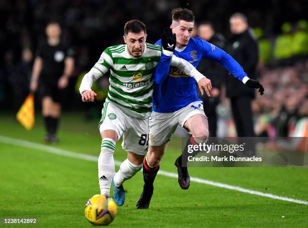 Josip Juranovic of Celtic battles for the ball with Ryan Kent of Rangers during the Cinch Scottish Premiership match between Celtic FC and Rangers FC...