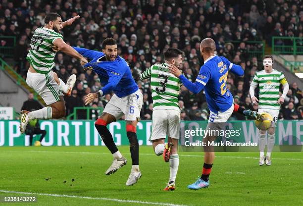 Cameron Carter-Vickers of Celtic challenges Conner Goldson of Rangers during the Cinch Scottish Premiership match between Celtic FC and Rangers FC at...