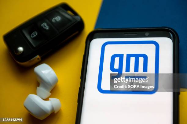 In this photo illustration a General Motors logo seen displayed on a smartphone.
