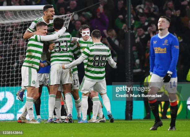 Reo Hatate of Celtic celebrates with his team-mates after scoring his team's second goal during the Cinch Scottish Premiership match between Celtic...