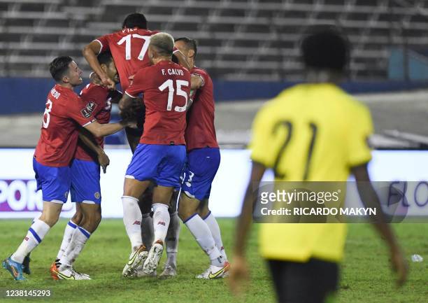 Costa Rica's players celebrate a goal by teammate Joel Campbell during the World Cup Qualifier CONCACAF match between Jamaica and Costa Rica at the...