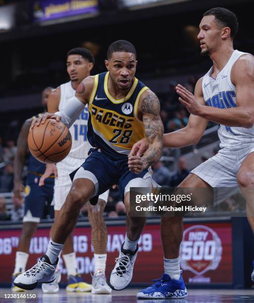 Keifer Sykes of the Indiana Pacers drives to the basket against Jalen Suggs of the Orlando Magic during the first half at Gainbridge Fieldhouse on...