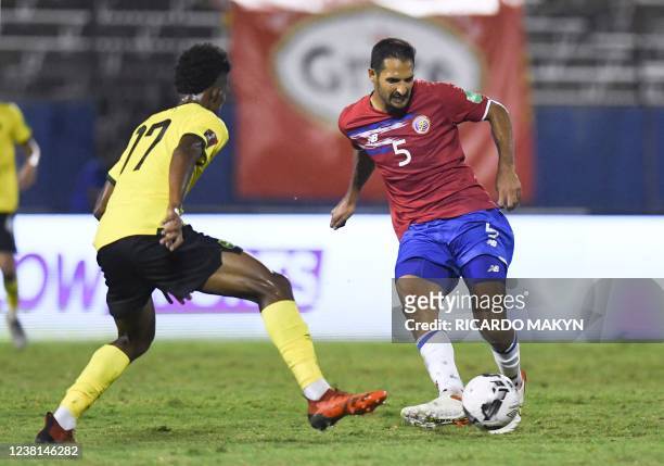 Jamaica's Richard King and Costa Rica's Celso Borges vie for the ball during the World Cup Qualifier CONCACAF match between Jamaica and Costa Rica at...