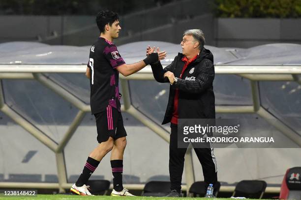 Mexico's forward Raul Jimenez celebrates with head coach Gerardo Martino after scoring against Panama during the FIFA World Cup Concacaf qualifier...