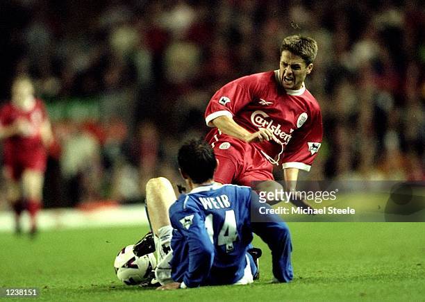 Michael Owen of Liverpool slides in with a two footed challenge on David Weir of Everton during the FA Premier League match between Liverpool and...