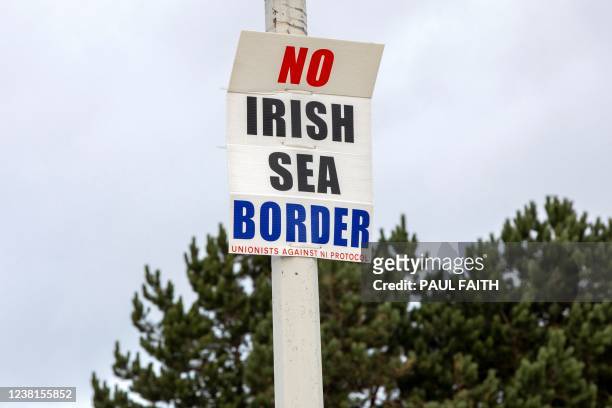 Poster reading "No Irish Sea Border" is pictured atttached to a lmap post outside of Larne port, north of Belfast in Northern Ireland, on February 3,...