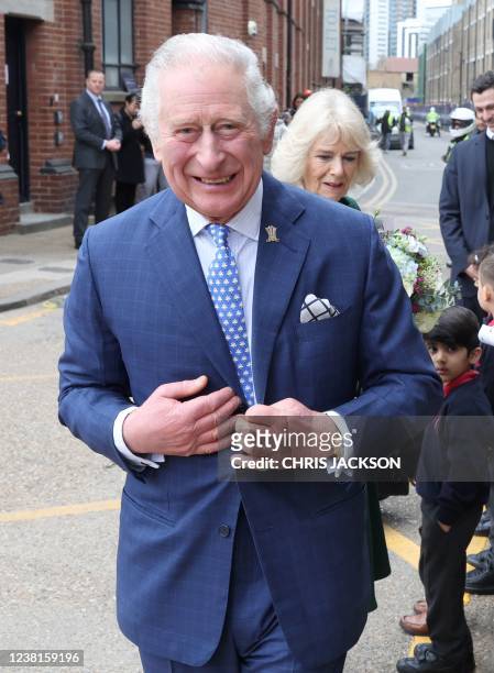 Britain's Prince Charles, Prince of Wales and Britain's Camilla, Duchess of Cornwall react as they arrive for their visit to The Prince's...