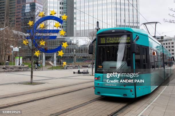 The Euro currency sign is seen in front of the former European Central Bank building as a tramway drives past, in Frankfurt am Main, western Germany,...