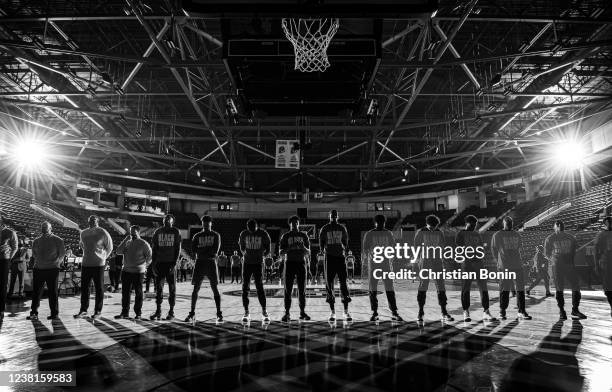 Raptors 905 players and coaches stand solemnly during the singing of the American and Canadian national anthems before an NBA G League game against...