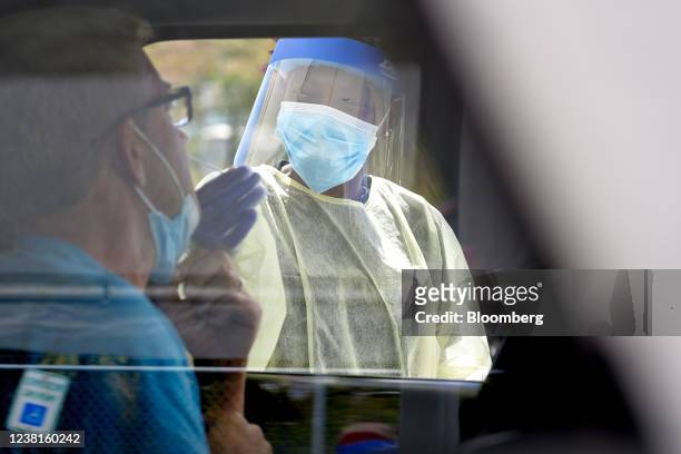 Healthcare worker conducts a swab test at a drive through Covid-19 testing site in Cruz Bay, Saint John, U.S. Virgin Islands, U.S., on Wednesday,...