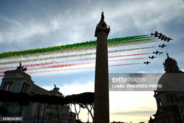 Planes of the Italian Air Force aerobatic unit Frecce Tricolori spread smoke with the colors of the Italian flag over the Unknown Soldier monument at...