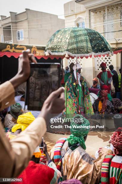 Man films the Emir of Kano, Muhammed Sanusi II, with his tablet during the Fatahul Mubin Islamic School graduation in the Old City on January 16,...
