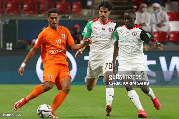 Pirae's forward Yohann Tihoni vies for the ball with Al-Jazira's forward Ahmed al-Hashmi and Al-Jazira's defender Abdulla Idrees during the 2021 FIFA...