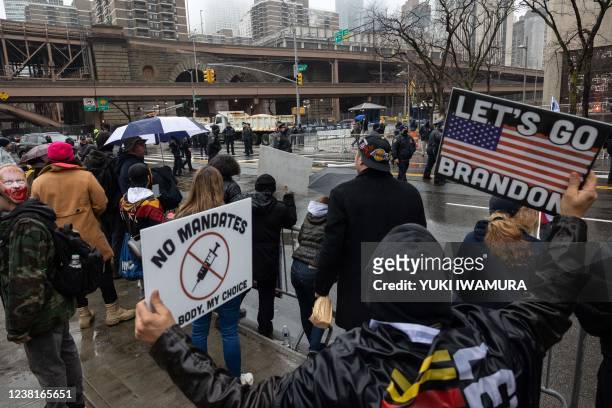 Anti-vaccine mandate protesters gather during the arrival of US President Joe Biden outside the New York Police Department Headquarters in New York...