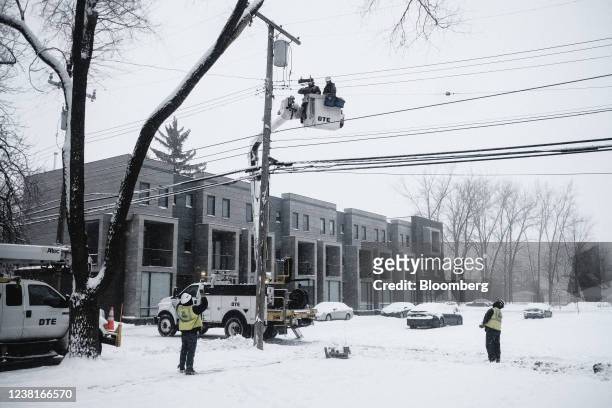 Energy electric workers repair utility poles during a snow storm power outage in Detroit, Michigan, U.S., on Thursday, Feb. 3, 2022. . A large storm...
