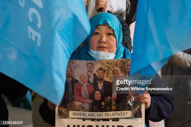 An Uyghur woman holds a picture of her relatives as Hongkongers, Tibetans, Uyghur Muslims, their Tigrayan allies and supporters protest in Piccadilly...