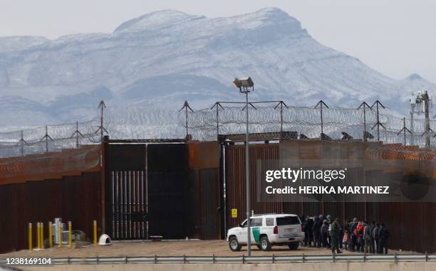 Border Patrol agents detain a group of migrants near the border wall, after they entered the United States from Ciudad Juarez, Chihuahua state,...