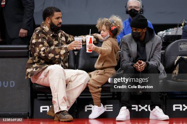 Toronto rapper Drake and his son Adonis cheers cups during the NBA game between the Toronto Raptors and the Chicago Bulls at Scotiabank Arena on...