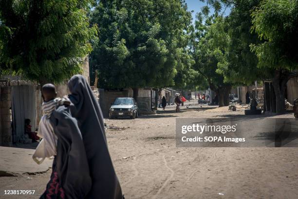 Woman seen with her baby walking in the streets of Maiduguri, the capital of Borno State. Islamic militant group Boko Haram, and more recently a...