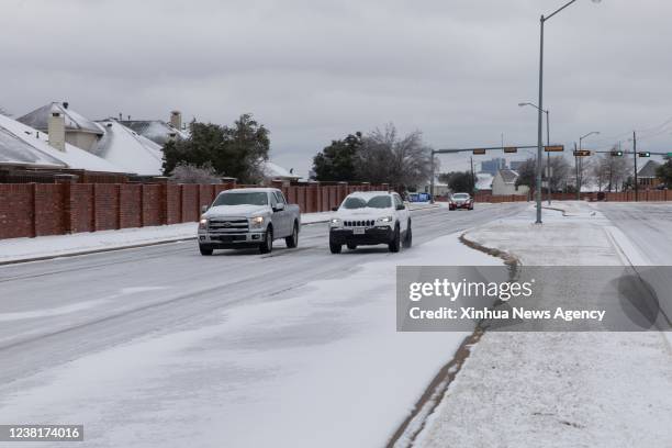 Photo taken on Feb. 3, 2022 shows cars on an icy road in Plano, a suburban city of Dallas, Texas, the United States. Texas, the second largest U.S....