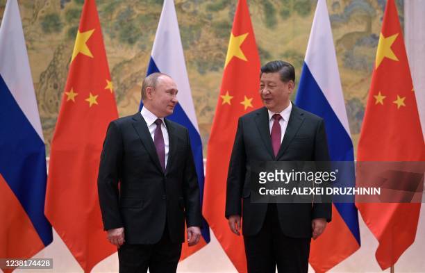Russian President Vladimir Putin and Chinese President Xi Jinping pose during their meeting in Beijing, on February 4, 2022.