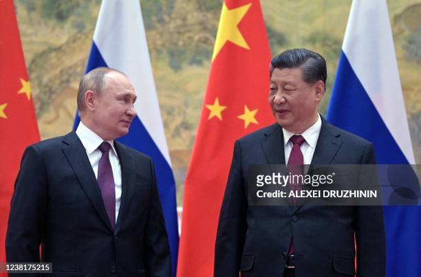 Russian President Vladimir Putin and Chinese President Xi Jinping pose for a photograph during their meeting in Beijing, on February 4, 2022.