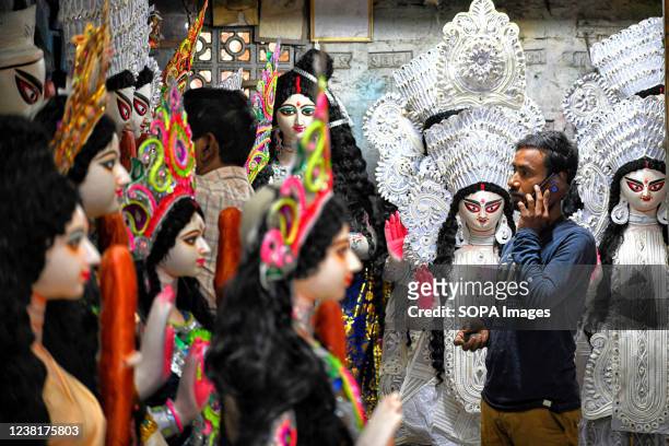 An artist stares at his creations displayed for sale before Saraswati Puja Festival at Kumartuli. Basant Panchami or Vasant Panchami is a Hindu...