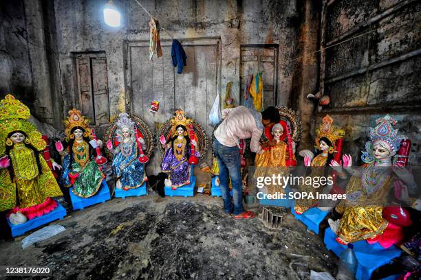 An artist puts the final touches to an idol of Hindu Goddess Saraswati during the preparations for the festival. Basant Panchami or Vasant Panchami...