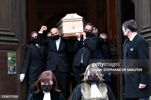 Visual artist and performer Krzysztof Leon Dziemaszkiewicz gestures as he carries the coffin of his partner after he attended the funeral service of...