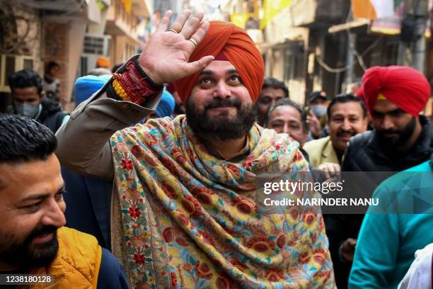 Punjab Congress party president and Congress party candidate Navjot Singh Sidhu gestures during a door to door election campaign for the upcoming...