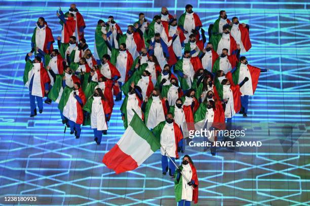 Italy's flag bearer Michela Moioli leads the delegation as they enter the stadium during the opening ceremony of the Beijing 2022 Winter Olympic...