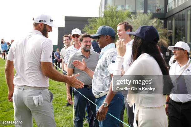 Dustin Johnson of the United States reacts to fans by the 18th green during day two of the PIF Saudi International at Royal Greens Golf & Country...