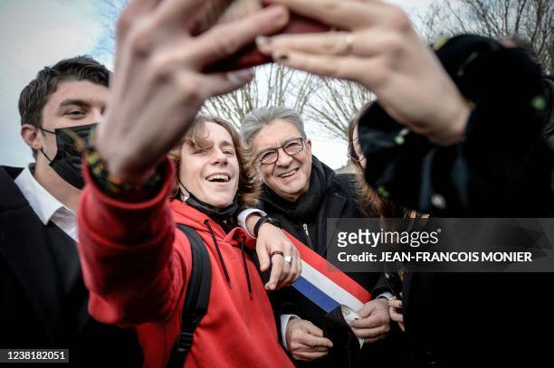 French leftist movement La France Insoumise presidential candidate Jean-Luc Melenchon poses for a picture with supporters at the end of a ceremony...