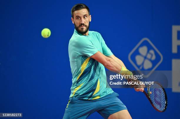 Bosnia's Damir Dzumhur eyes the ball as he returns to Serbia's Filip Krajinovic during their singles tennis match of the Open Sud de France ATP World...