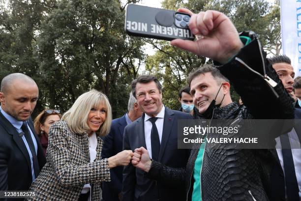 French president's wife Brigitte Macron poses for a passer-by with French mayor of Nice Christian Estrosi during the closing of the 2022 edition of...